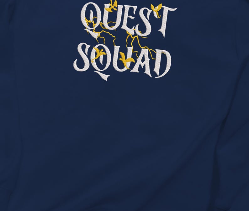 May include: Navy blue sweatshirt with white embroidered text that reads "QUEST SQUAD" with yellow embroidered birds and lightning bolts.