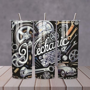 May include: Three black and silver stainless steel tumblers with a mechanic theme. The tumblers are covered in a graphic design of car parts, tools, and the word "Mechanic".