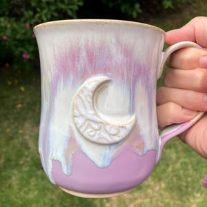 Handmade ceramic cauldron moon Mug. Pale purple and white with pinky purple drippy glaze.