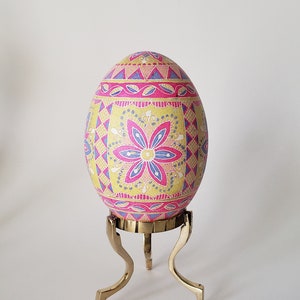 Pysanka Easter egg traditional batik art egg, Ukrainian pysanka egg ornament on goose egg shell in pink and yellow