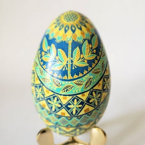 Ukrainian goose pysanka egg sunflower pysanka symbol of my culture in blue and yellow colors