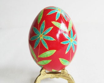 Red Ukrainian Easter egg pysanka hand painted with hot beeswax