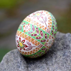 Green Pysanka Ukrainian Easter egg floral motif pattern decorative cross branches leaves flowers, hand-painted Pysanka batik art ornament