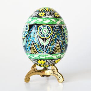 Floral Pysanky egg ornament Ukrainian Easter egg blue-green colors symbolize Spring, flowers with leaves and branches fancy Pysanka pattern
