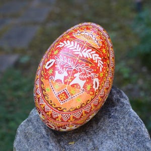 Christmas pysanka Ukrainian Easter egg ornament on real goose eggshell, deer design fancy batik art egg red-orange pattern, Easter eggs gift