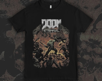 May include: A black short-sleeve t-shirt featuring a graphic print of the Doom Eternal logo in white text above a detailed, dark-toned illustration of a character in armor battling various creatures amidst a fiery, orange-hued landscape.
