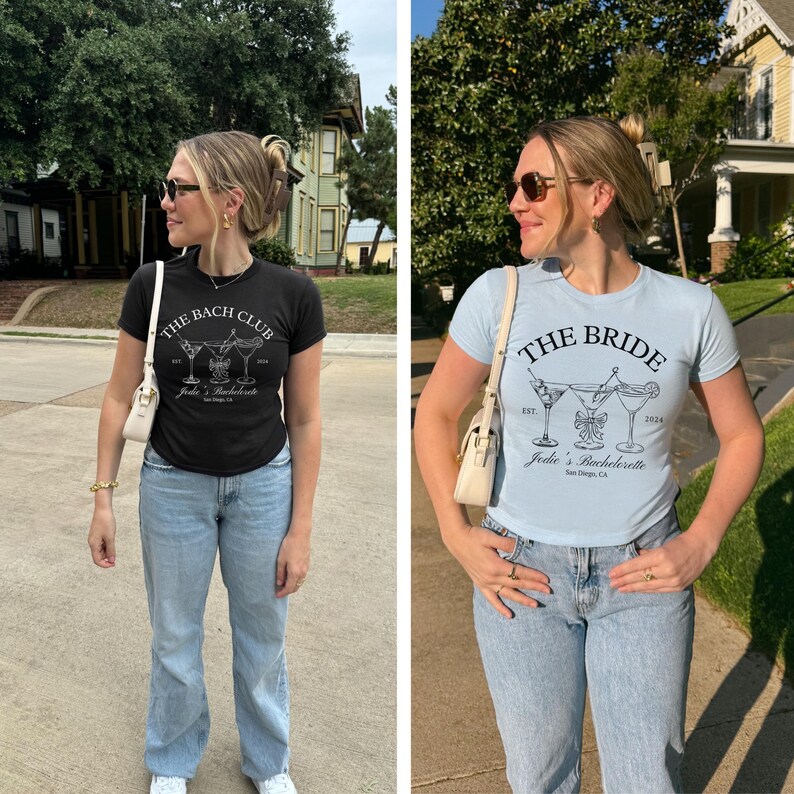 May include: Two t-shirts, one black and one light blue, with matching graphic designs. The black shirt reads "The Bach Club" with cocktail illustrations. The light blue shirt says "The Bride" with similar cocktail art. Both shirts are for a bachelorette party.