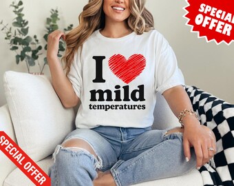 Op de afbeelding: Wit T-shirt met de tekst "I love mild temperatures" in zwarte letters en een rode hartafbeelding. Het shirt wordt gedragen met een blauwe jeans. Een rode "Special Offer" banner staat in de afbeelding.