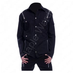 May include: Black long-sleeve shirt with silver zippers on the chest, shoulders, and sleeves. The shirt has two chest pockets and silver button closures. The collar is a classic button-down style. The shirt is part of a clothing collection.