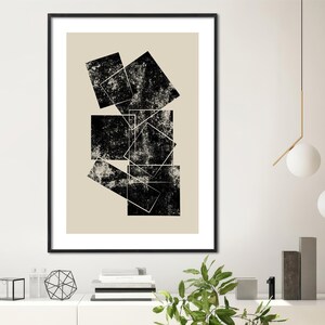 May include: Black and white abstract geometric art print with a beige background. The print features overlapping squares with a distressed texture.