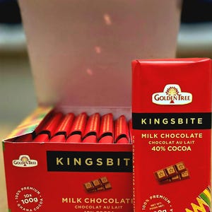 May include: A box of 10 Golden Tree Kingsbite milk chocolate bars, each bar is 100g and made with 40% cocoa. The box is red with gold lettering and a picture of a chocolate bar with stars on it. The bars are individually wrapped in red foil.