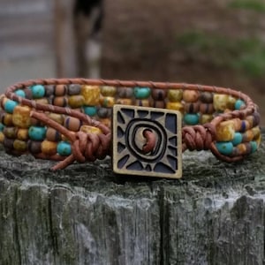 Indian Summer, a hand loomed beaded leather bracelet. Czech picasso glass beads,distressed natural leather. Vibrant copper square sun button