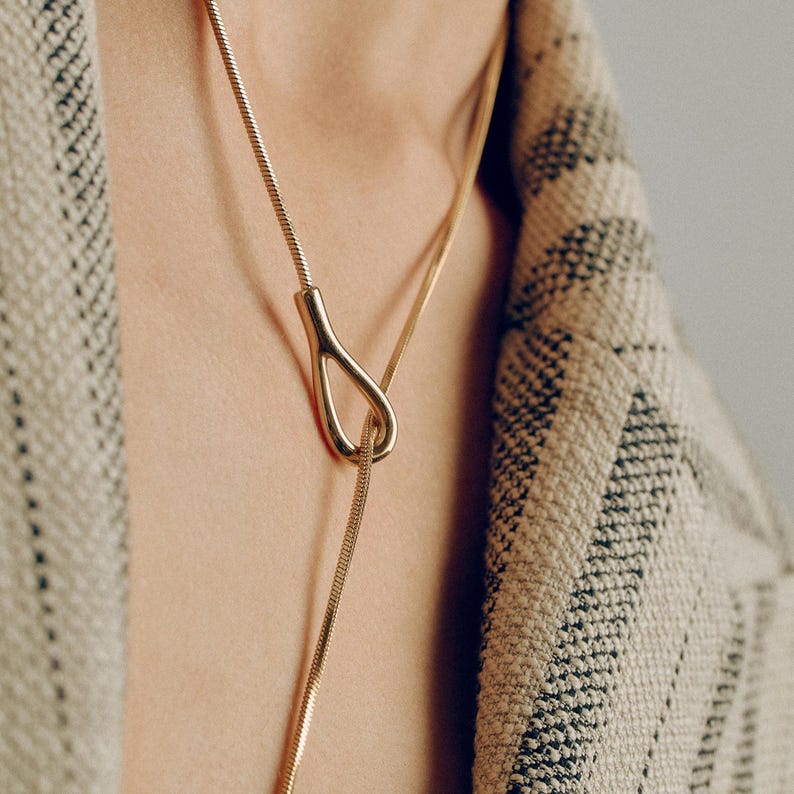 Adjustable knot layered necklace with a Y-lariat drop chain and a gold or silver toggle pendant. Versatile design can be worn long, as a choker, or layered with other necklaces. A minimalist long drop chain necklace perfect for everyday wear, Thanksgiving gatherings, Christmas parties, New Year celebrations, and holiday gifting.