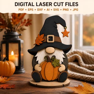 May include: A layered wooden gnome decoration featuring a black witch hat with a brown belt, a buckle, and an orange star charm. The gnome has a white beard, holds an orange pumpkin with a green leaf, and stands on a circular base. Text reads DIGITAL LASER CUT FILES PDF EPS DXF AI SVG PNG JPG.