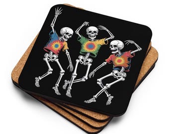 May include: A stack of square coasters with a black background. Each coaster features a colorful illustration of three dancing skeletons wearing brightly colored shirts with a sunburst design. The coasters are made of cork.