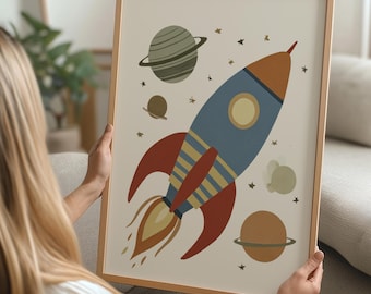 May include: A framed art print featuring a cartoon rocket ship blasting off into space. The rocket is blue, orange, and red, with yellow flames. Planets and stars are scattered around the rocket on a cream background. The frame is a light wood color.