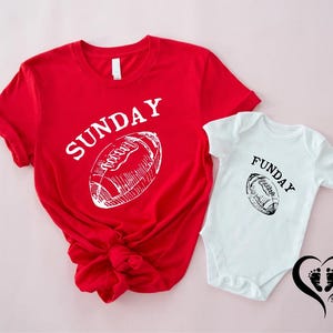 Puede incluir: Camiseta roja con la palabra "SUNDAY" y un gr&aacute;fico de f&uacute;tbol americano. Un body blanco con la palabra "FUNDAY" y un gr&aacute;fico de f&uacute;tbol americano est&aacute; al lado de la camiseta. Fondo rosa.