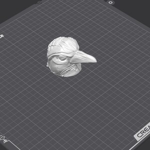 May include: A 3D printed model of a bird head with a long beak. The model is printed in white plastic and has a textured surface. The model is sitting on a gray textured surface with a grid pattern.