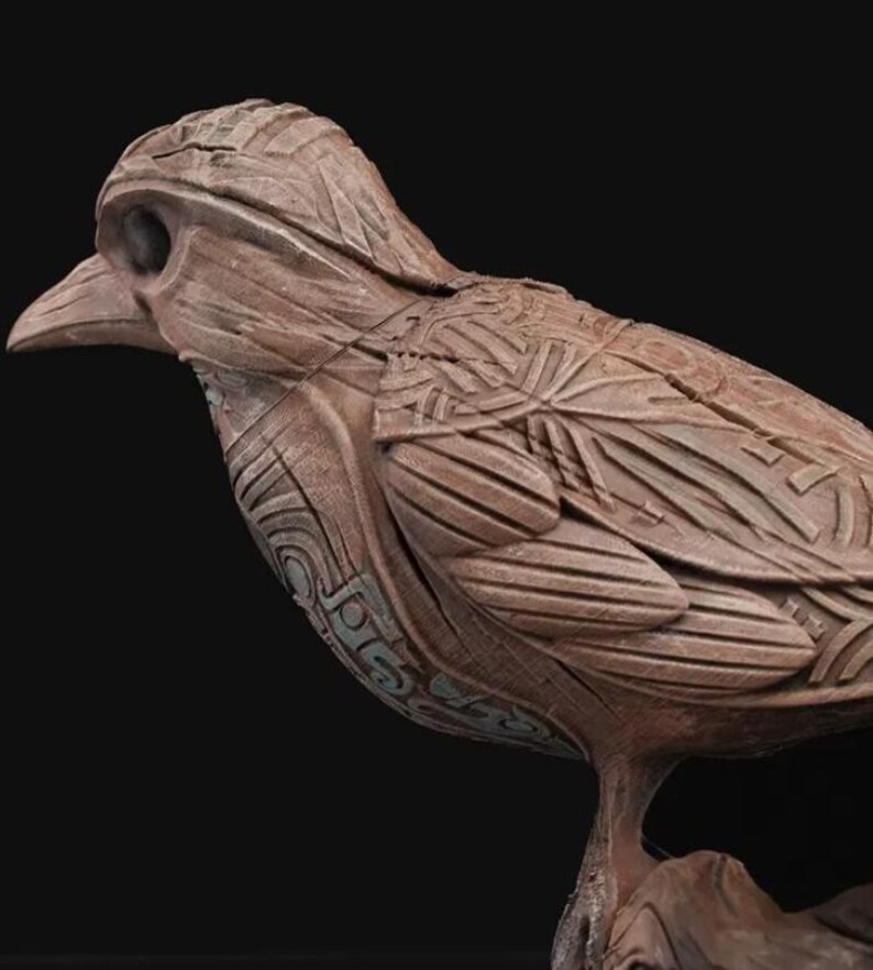 May include: A detailed wooden sculpture of a bird with intricate carvings and a textured surface. The bird is perched on a branch.