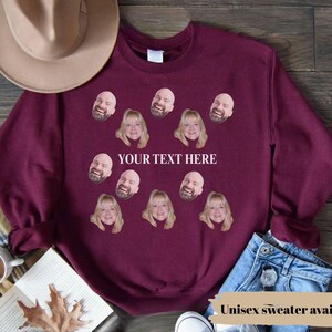 May include: Burgundy unisex sweatshirt with custom face prints and the text "YOUR TEXT HERE". The sweatshirt features multiple face graphics and the text "Unisex sweater available".