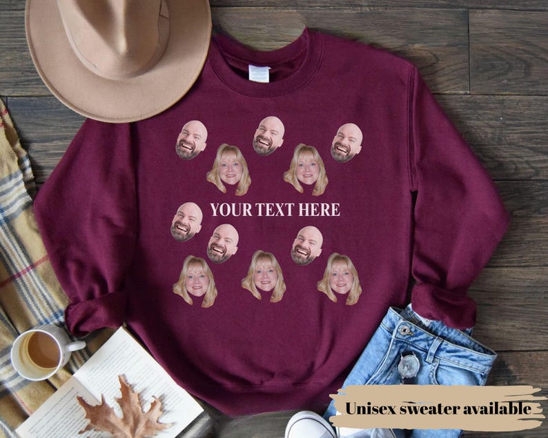 May include: Burgundy unisex sweatshirt with custom face prints and the text "YOUR TEXT HERE". The sweatshirt features multiple face graphics and the text "Unisex sweater available".