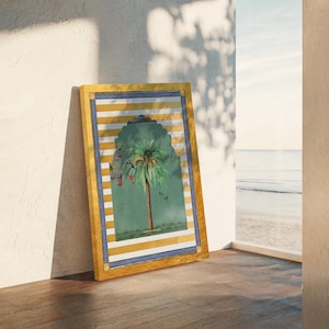 May include: A framed print of a palm tree in a green archway with yellow and white stripes. The frame is gold with a blue inner border.