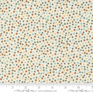 May include: Cream-colored fabric with a repeating pattern of small geometric shapes. The design includes stars, circles, triangles, diamonds, and hexagons in shades of brown, green, blue, and yellow. The fabric has a ruler along the bottom edge.