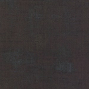 May include: A dark grey textured fabric with a subtle sheen. The fabric has a slightly rough texture and a slightly uneven surface.