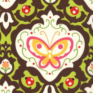 May include: A brown and green damask pattern fabric with a white butterfly and red ladybugs. The butterfly has pink wings and a yellow body.