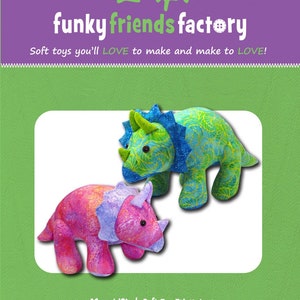 May include: A sewing pattern for two 18-inch soft toy Triceratops dinosaurs. The pattern is called "Tristan & Trixie TRICERATOPS". One dinosaur is pink and the other is blue and green.