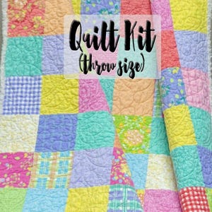 May include: A patchwork quilt kit in throw size. The quilt displays squares of pastel colours, including pink, yellow, blue, and green. The text "Quilt Kit (Throw size)" is overlaid on the quilt.