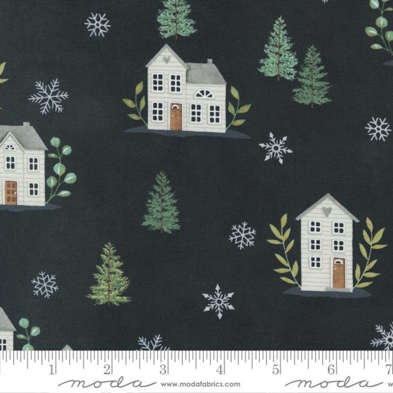 May include: A black fabric with a white house, green trees, and snowflakes pattern. The fabric has a white ruler with the word "moda" printed on it.