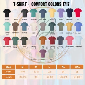May include: A color chart for Comfort Colors 1717 t-shirts displaying 27 different shirt colors with labels including black, white, pepper, seafoam, blue jean, butter, violet, true navy, red, chalky mint, espresso, ice blue, ivory, gray, blue spruce, moss, mustard, flo blue, watermelon, light green, sage, orchid, yam, crimson, denim, crunchberry, chambray, blossom, berry, and bay, with a size chart showing width and length in inches for sizes S, M, L, XL, and 2XL.