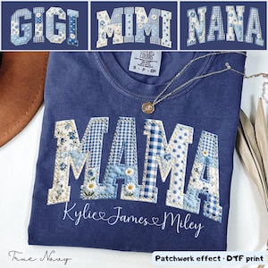 May include: A navy blue t-shirt with the word "MAMA" in a patchwork design, featuring blue floral, gingham, and polka dot patterns. The names "Kylie James & Miley" are below the word "MAMA". The image also shows the words "GIGI", "MIMI", and "NANA".