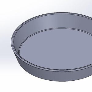 May include: A round, silver-coloured baking pan with a smooth, flat bottom and slightly raised edges.