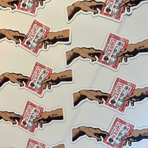 May include: Multiple stickers featuring a hand reaching out to another hand, holding a red package with the word "SCRAPPLE" printed on it. The stickers are printed on a white background.