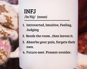 May include: White ceramic mug with the text "INFJ" and a definition. The definition includes personality traits such as "Introverted, Intuitive, Feeling, Judging" and "Future-seer. Present-avoider."