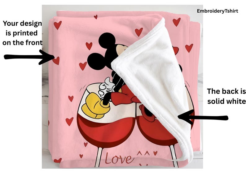 a pink blanket with a cartoon character, specifically Mickey Mouse, sitting in a wine glass. The blanket is embroidered with the character and the word "Love".