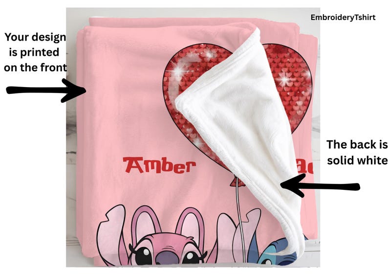 a pink blanket with a cartoon character design, including a heart-shaped balloon and a character with a pink hat.