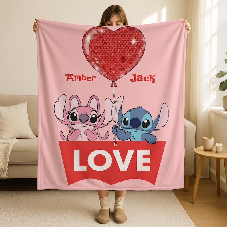A woman holding a pink blanket with a heart-shaped balloon and the characters Stitch and Jack.