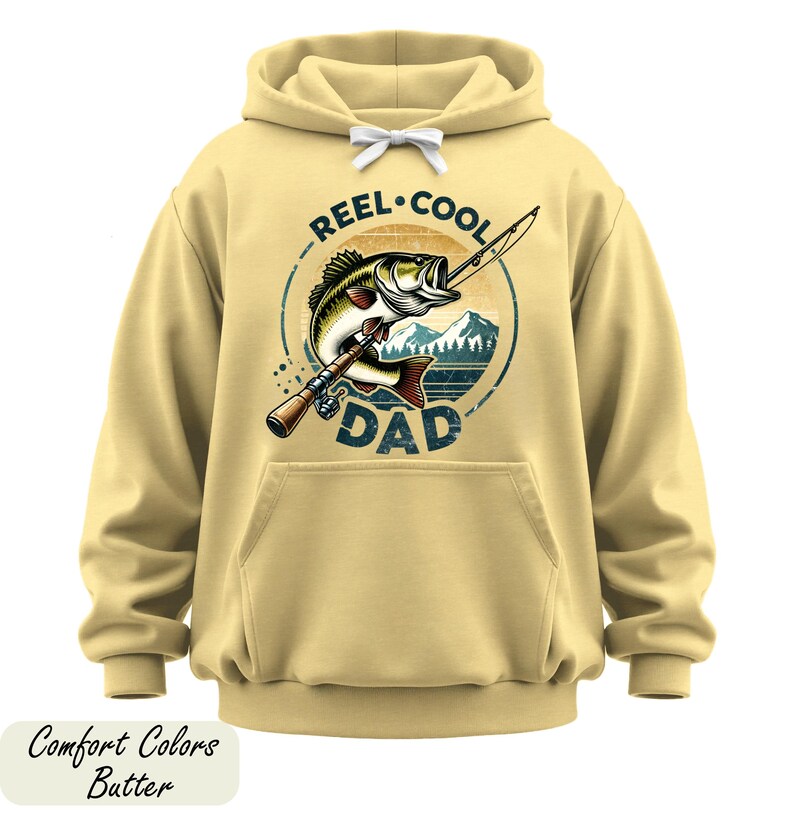 A yellow hoodie with a graphic design featuring a fish and the text "REEL. COOL. DAD" printed on it.