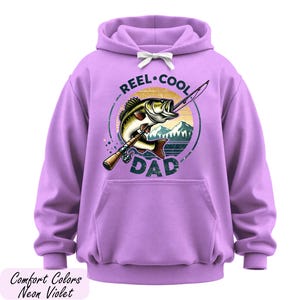 A purple hoodie with a graphic design featuring a fish and the text "REEL-COOL DAD" printed on it.