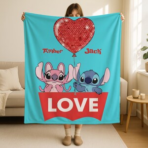 A woman holding a blanket with a heart-shaped balloon and the characters Stitch and Jack from the movie Lilo & Stitch.