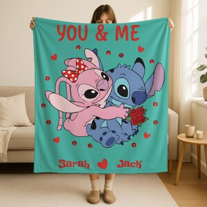 A woman holding a blanket with a cartoon image of two characters, a pink bunny and a blue dog, along with the text "YOU & ME" and the names "Sarah" and "Jack".