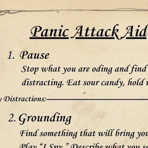 May include: A vintage-style card titled "Panic Attack Aid" with instructions for managing panic. The card features a decorative border and handwritten text, including steps for pausing and grounding. The text is in black on a cream-colored background.