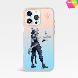 May include: A clear phone case featuring a character illustration. The design showcases a figure with white hair, wearing a blue and black outfit, holding a futuristic device. The background transitions from blue to peach. The top right corner has the word "INKRATE" in a colorful design.