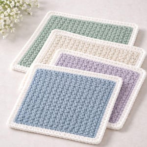 May include: A white ceramic mug with a black handle and the text "But First, Coffee" in a black, handwritten-style font. The mug is on a white surface.