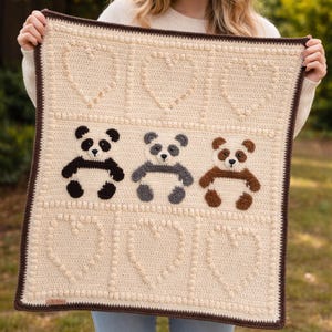 May include: A white ceramic mug with a black handle and the text "But First, Coffee" in a black, handwritten-style font. The mug is on a white surface.