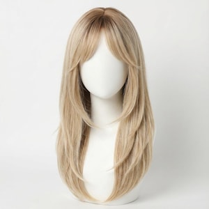 May include: A layered, long blonde wig with a dark root and a light blonde color. The wig has a side-swept bang and is styled on a white mannequin head. The hair is straight and has a natural look.