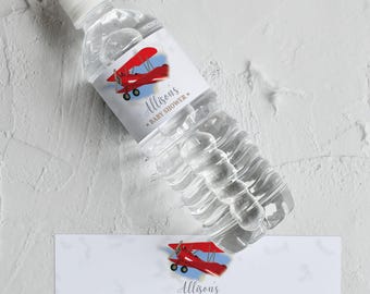 May include: A clear plastic water bottle with a white cap and a label featuring a red biplane illustration. The label reads "Allison's BABY SHOWER" in script font. A matching label is below the bottle.